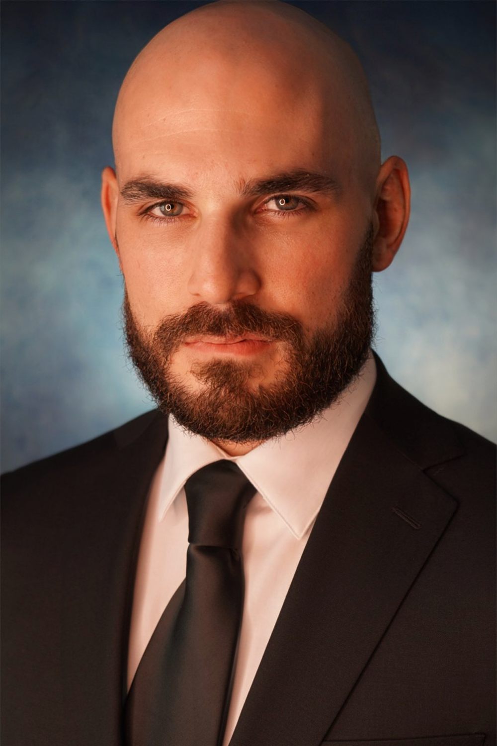 Sirko in a dark suit and black tie