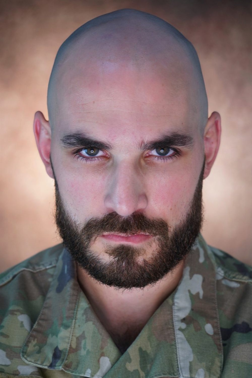 Close headshot of Sirko in a camouflage uniform